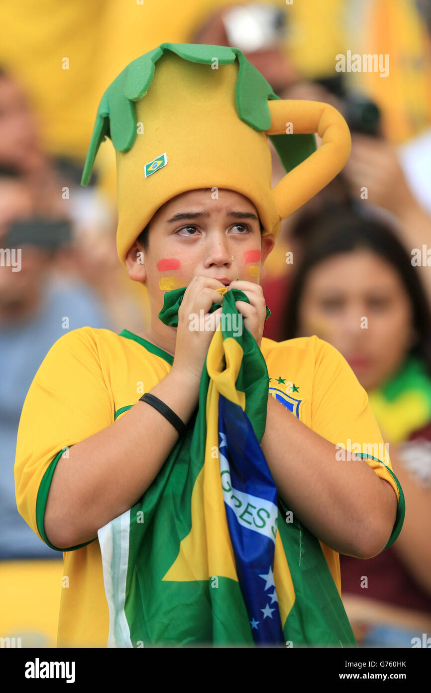 A Brazil fan reacts during his team's penalty shoot-out victory against Chile before the FIFA World Cup, Round of 16 match between Uruguay and Colombia at the Estadio do Maracana, Rio de Janeiro, Brazil. PRESS ASSOCIATION Photo. Picture date: Saturday June 28, 2014. Photo credit should read: Mike Egerton/PA Wire. RESTRICTIONS: Editorial use only. No commercial use. No use with any unofficial 3rd party logos. No manipulation of images. No video emulation Stock Photo
