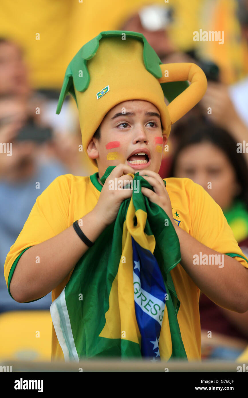 A Brazil fan reacts during his team's penalty shoot-out victory against Chile before the FIFA World Cup, Round of 16 match between Uruguay and Colombia at the Estadio do Maracana, Rio de Janeiro, Brazil. PRESS ASSOCIATION Photo. Picture date: Saturday June 28, 2014. Photo credit should read: Mike Egerton/PA Wire. RESTRICTIONS: Editorial use only. No commercial use. No use with any unofficial 3rd party logos. No manipulation of images. No video emulation Stock Photo