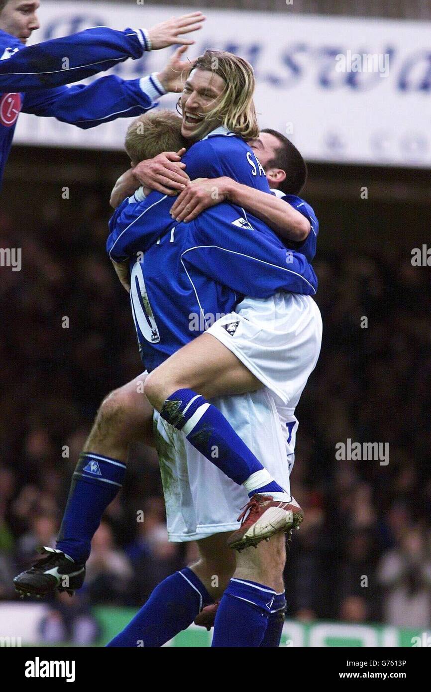 Leicester City's Robbie Savage (centre) celebrates teammate James Scowcroft's goal against Chelsea, during his sides 2-3 FA Barclaycard Premiership loss at Leicester's Filbert Street ground. Stock Photo