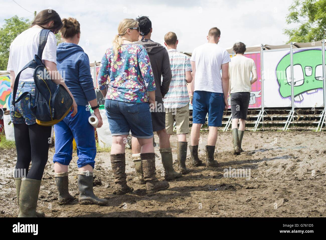 Festivalgoers queue for new compost toilets, at the Glastonbury Festival, at Worthy Farm in Somerset. Stock Photo