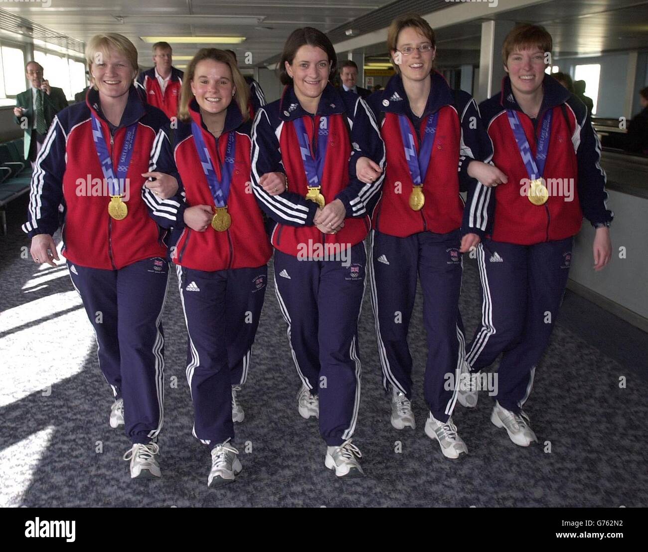 Great Britain's Curling team, Rhona Martin, Fiona Macdonald, Debbie Knox, Janice Rankin, Margaret Morton arrive at London's Heathrow Airport, holding the Gold Medals that they won during the Winter Olympics at Salt Lake City. Stock Photo