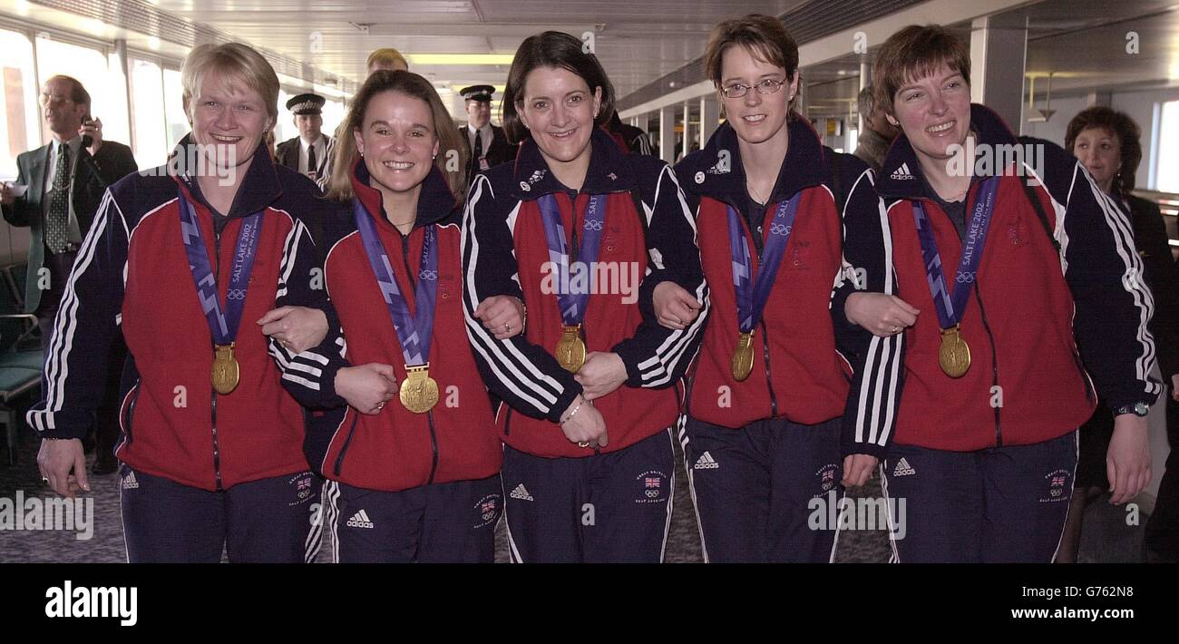 Great Britain's Curling team, Rhona Martin, Fiona Macdonald, Debbie Knox, Janice Rankin, Margaret Morton arrive at London's Heathrow Airport, holding the Gold Medals that they won during the Winter Olympics at Salt Lake City. Stock Photo