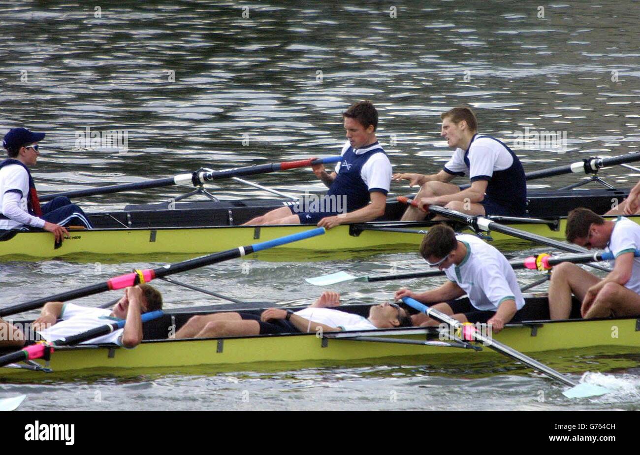 Dejected Cambridge crew members lie down in their boat after being beaten by Oxford, in the 148th University Boat race on the River Thames. Stock Photo