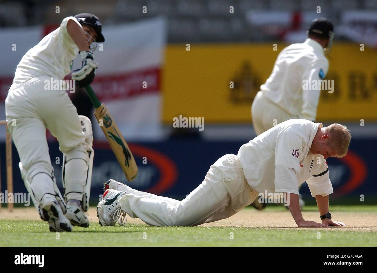 England's Matthew Hoggard picks himself up off the floor as New Zealand's Adam Parore (left) and Chris Harris add more runs to their total during the third day of the third and final test match at Basin Reserve, Auckland. * At the close of play England were 12 for 3 in reply to New Zealand's 202 all out. Stock Photo