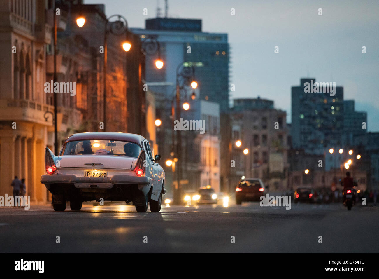 Classic cars driving along The Malecon (coast road) in Havana, Cuba Stock Photo