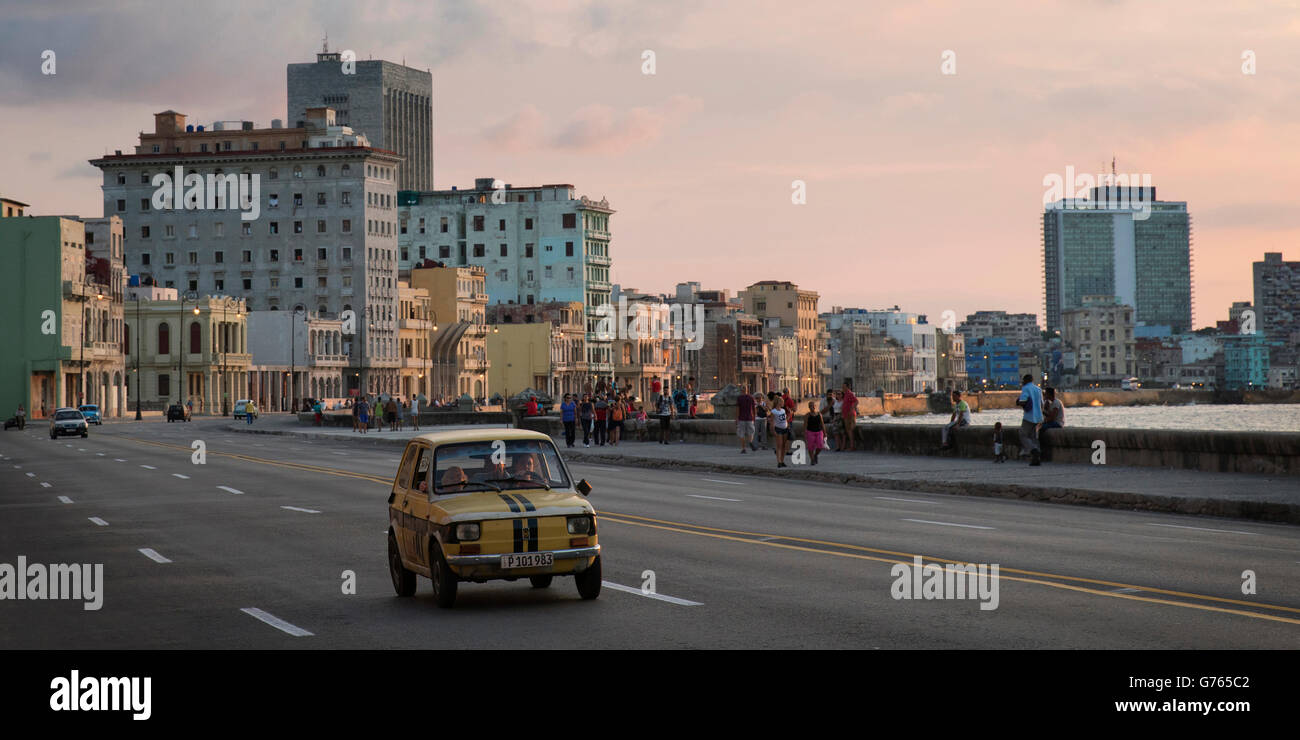 Old car driving along The Malecon (coast road) in Havana, Cuba Stock Photo