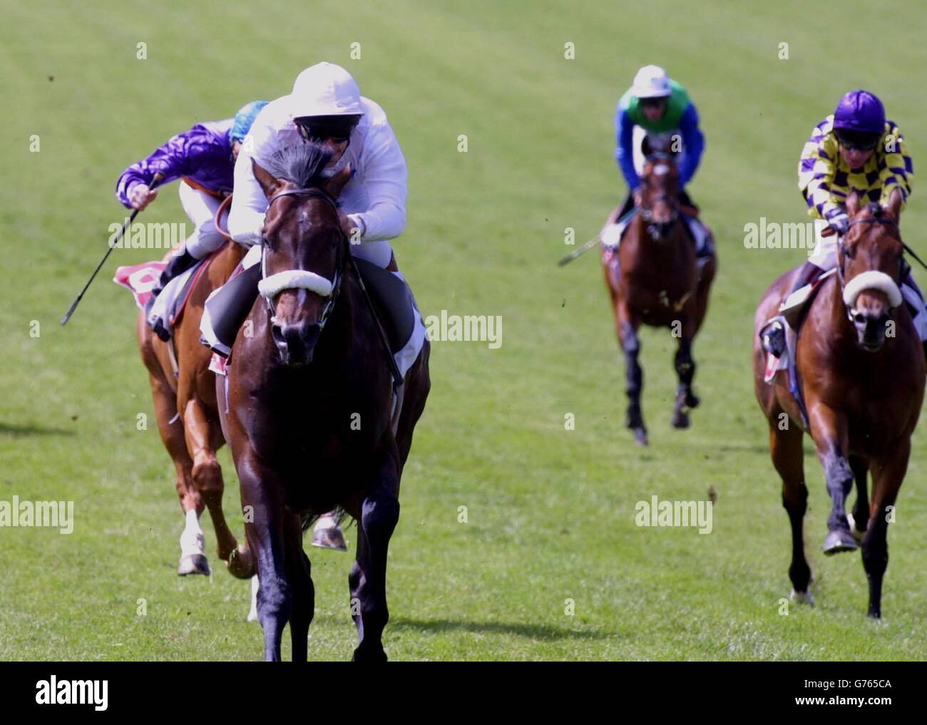 Newmarket Racing. Millennium Dragon ridden by Franki Dettori (left) wins the Milcars King Charles II Stakes at Newmarket. Stock Photo