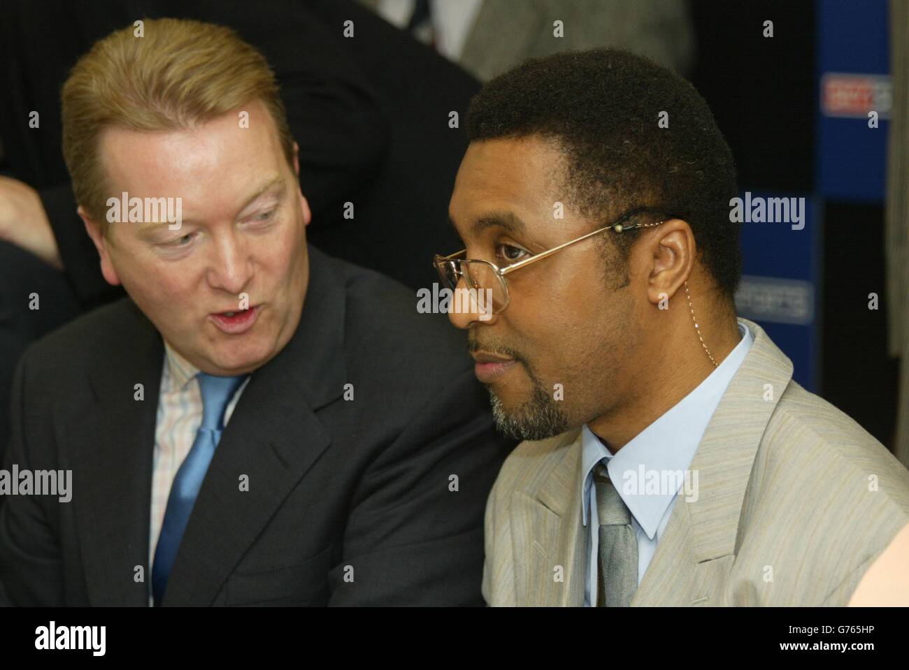 Promoter Frank Warren talks with British boxer Michael Watson, who suffered brain damage in a world championship super middle-weight contest against Chris Eubank in 1991, at the launch in London, of the Michael Watson Testimonial Evening. * The 1,000 -a-table event on July 8, hopes to raise money to improve the quality of his life. Stock Photo