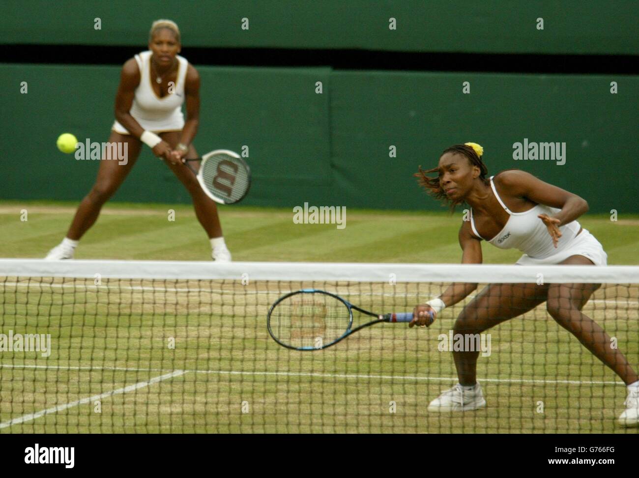 EDITORIAL USE ONLY, NO COMMERCIAL USE. Serena and Venus Williams from the USA in action in the Ladies' Doubles Final at Wimbledon which they won in straight sets 6:2/7:5 against Virgina Ruano Pascual from Spain and Paola Suarez. * of Argentina. The Williams sisters competed against each other in the Ladies' Singles Final yesterday, with Serena beating her older sister in straight sets. Stock Photo