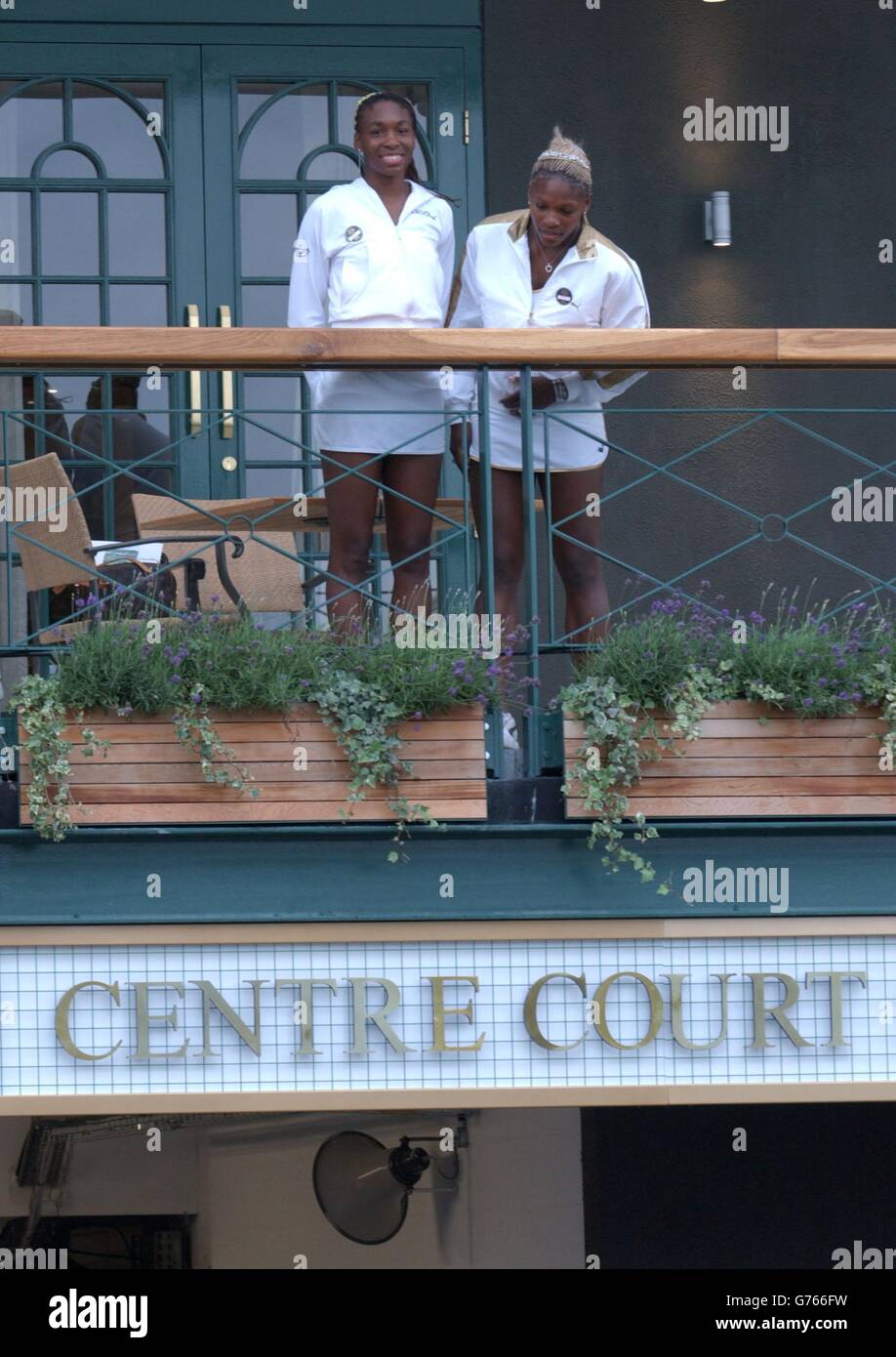 Wimbledon Ladies' Doubles and Singles Champions Serena (right) and Venus Williams from the USA take in the view from the Centre Court members only balcony at The All England Lawn Tennis Club. * The sisters won the Ladies' Doubles Final today, and Serena beat Venus in the Ladies' Final yesterday. Venus Williams has won the singles title in both 2000 and 2001. Champions are rewarded with life membership to the famous club. Stock Photo
