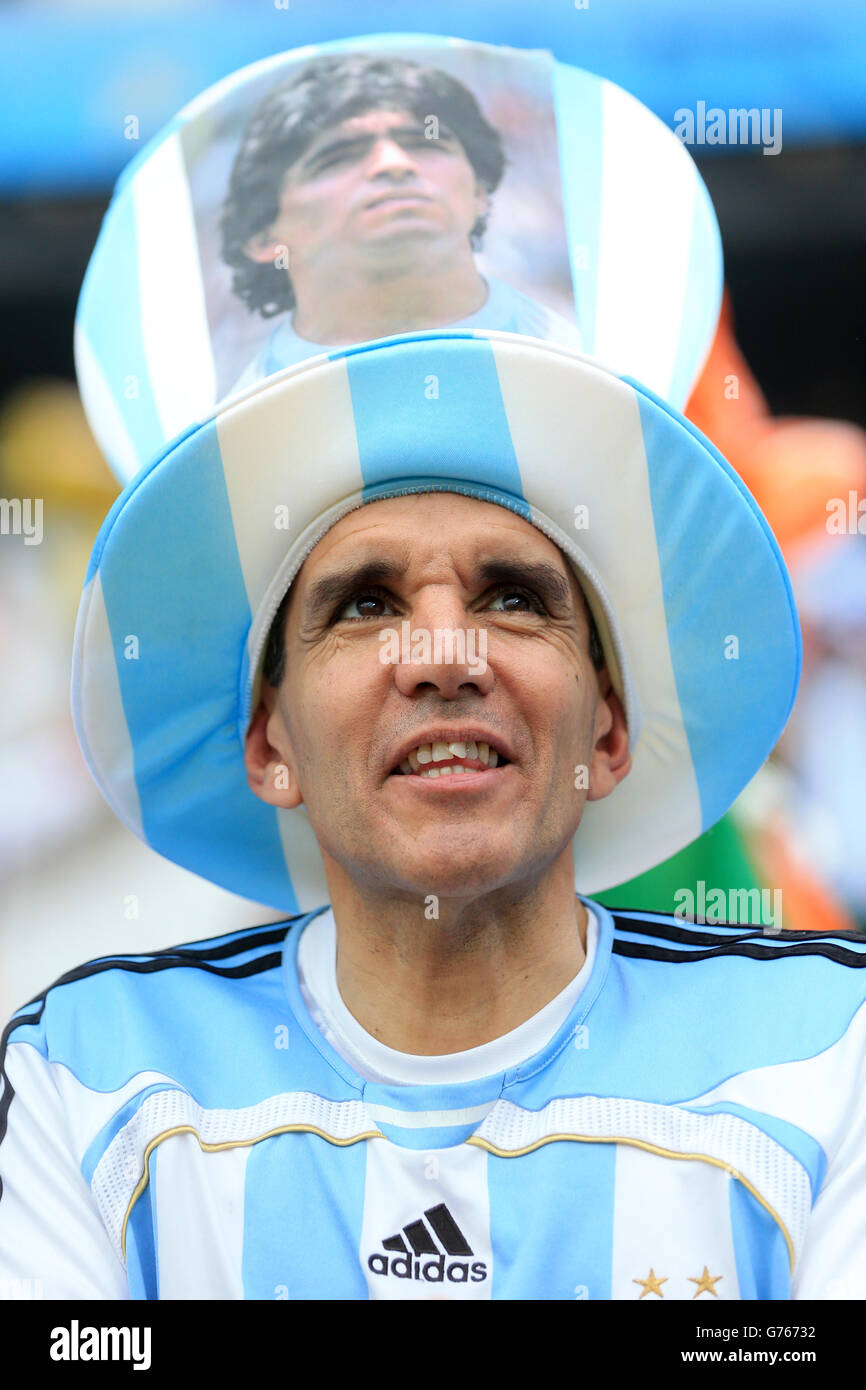 An Argentina fan shows his support in the stands with a Diego Maradona hat before the FIFA World Cup Semi Final at the Arena de Sao Paulo, Sao Paulo, Brazil. Stock Photo