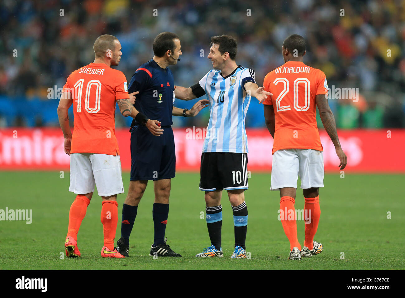 Argentina's Lionel Messi (centre) argues a decision with referee Cuneyt Cakir during the FIFA World Cup Semi Final at the Arena de Sao Paulo, Sao Paulo, Brazil. Stock Photo