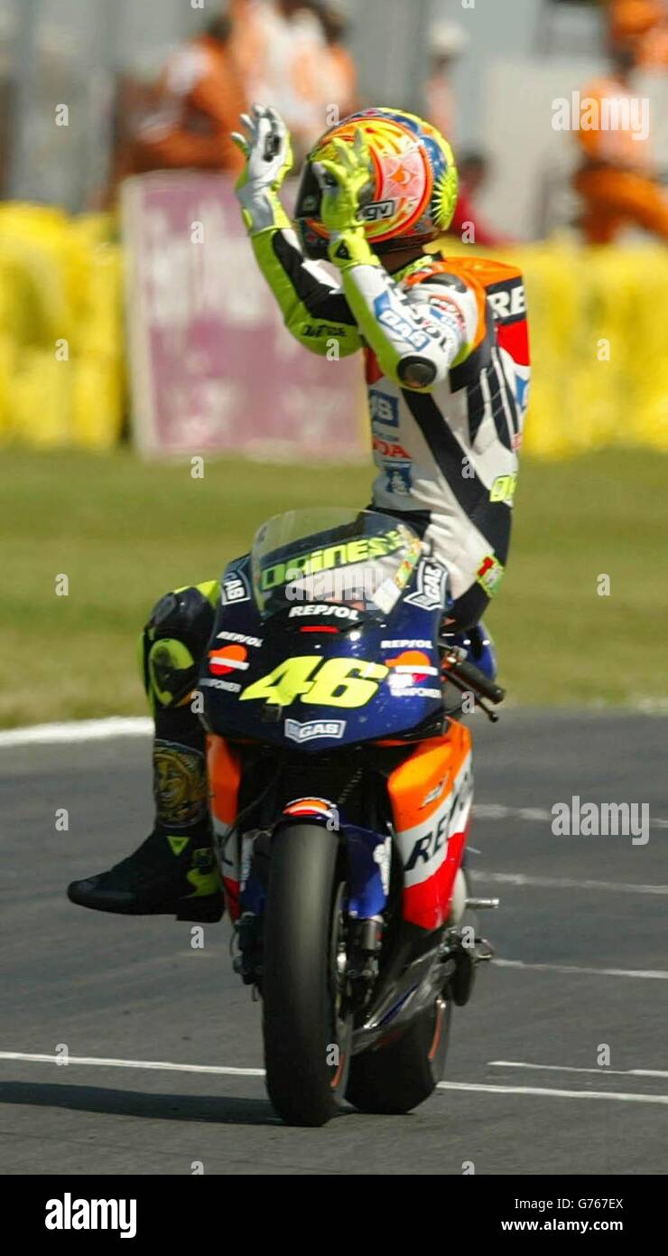 Italian Honda rider Valentino Rossi celebrates by sitting side saddle after  crossing the line to win the MotoGP British Grand Prix at Donington,  Leicestershire Stock Photo - Alamy