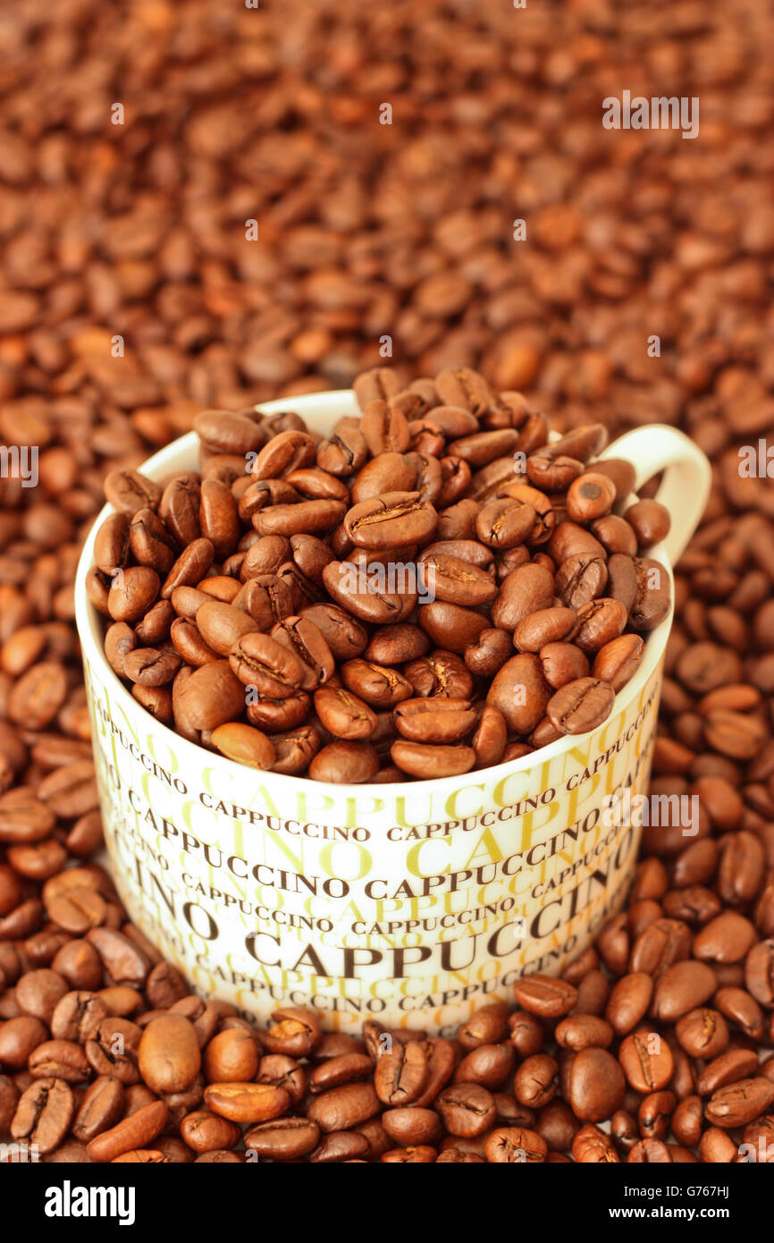 Coffee beans in a cappuccino cup Stock Photo Alamy