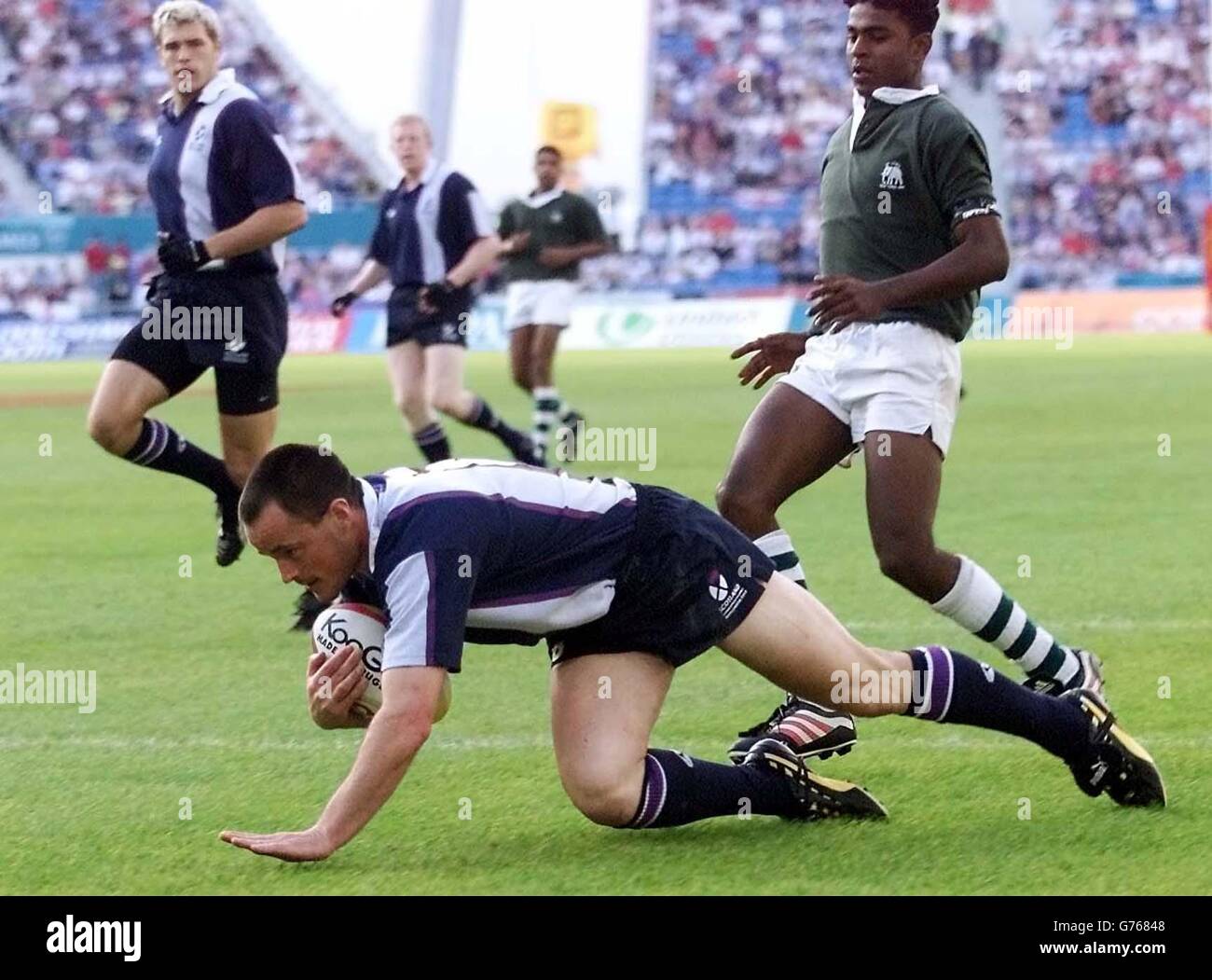 Scotland's Scott Paterson scores his team's opening try during their rugby sevens quarter final game against Sri Lanka in the 2002 Commonwealth Games at the City of Manchester Stadium, Manchester. Stock Photo