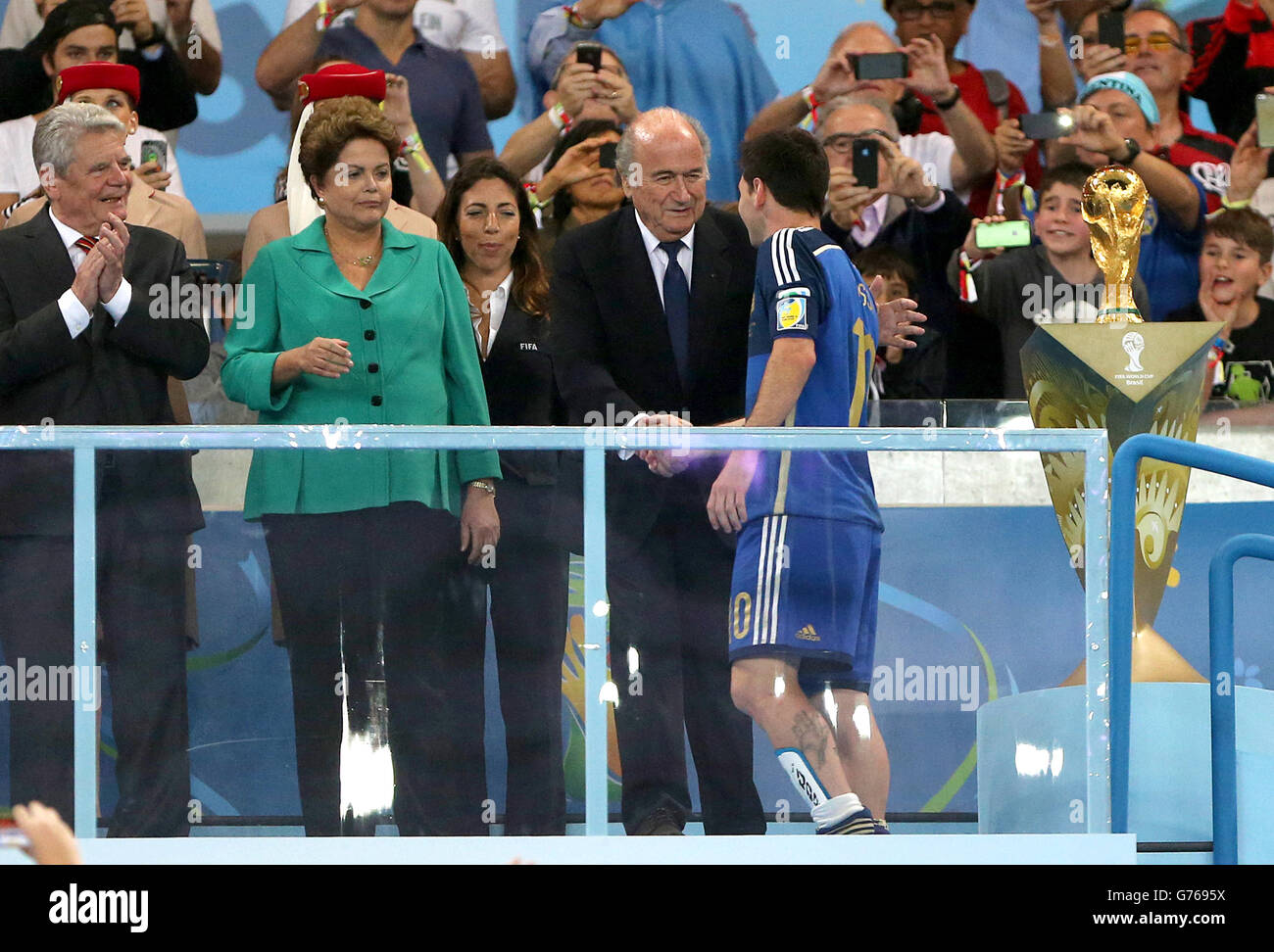 Soccer - FIFA World Cup 2014 - Final - Germany v Argentina - Estadio do Maracana. Argentina's Lionel Messi looks dejected as he collects his Golden Ball award from FIFA President Sepp Blatter Stock Photo