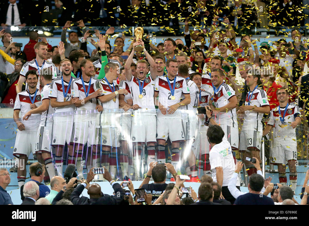 Germany's Andre Schurrle (centre) and his team-mates celebrate with the FIFA World Cup trophy after the game Stock Photo