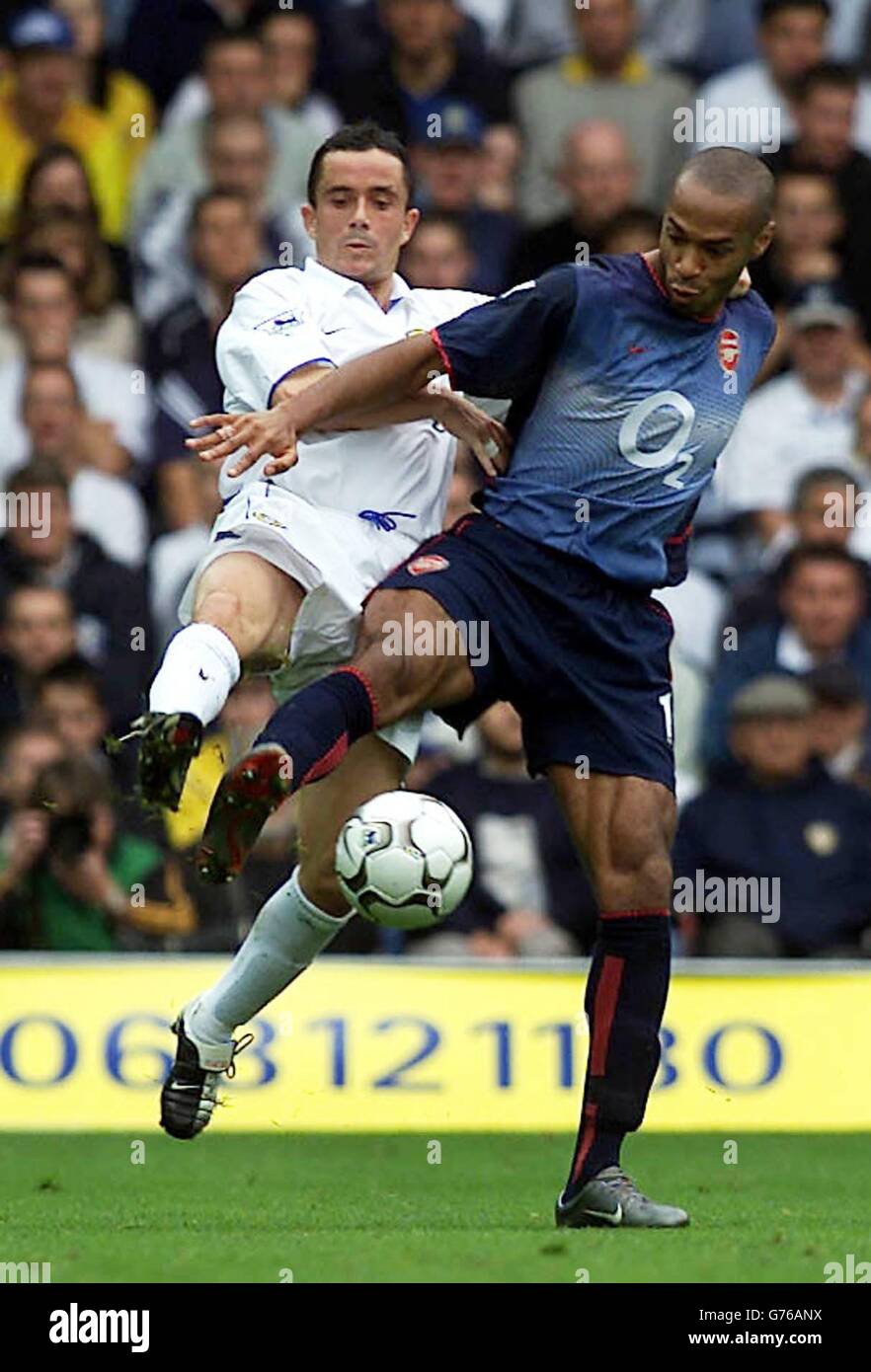 Leeds United's Gary Kelly (left) battles for the ball against Arsenal's Thierry Henry during their FA Barclaycard Premiership match at Leeds' Elland Road ground, Yorkshire. Arsenal defeated Leeds United 4-1. Stock Photo