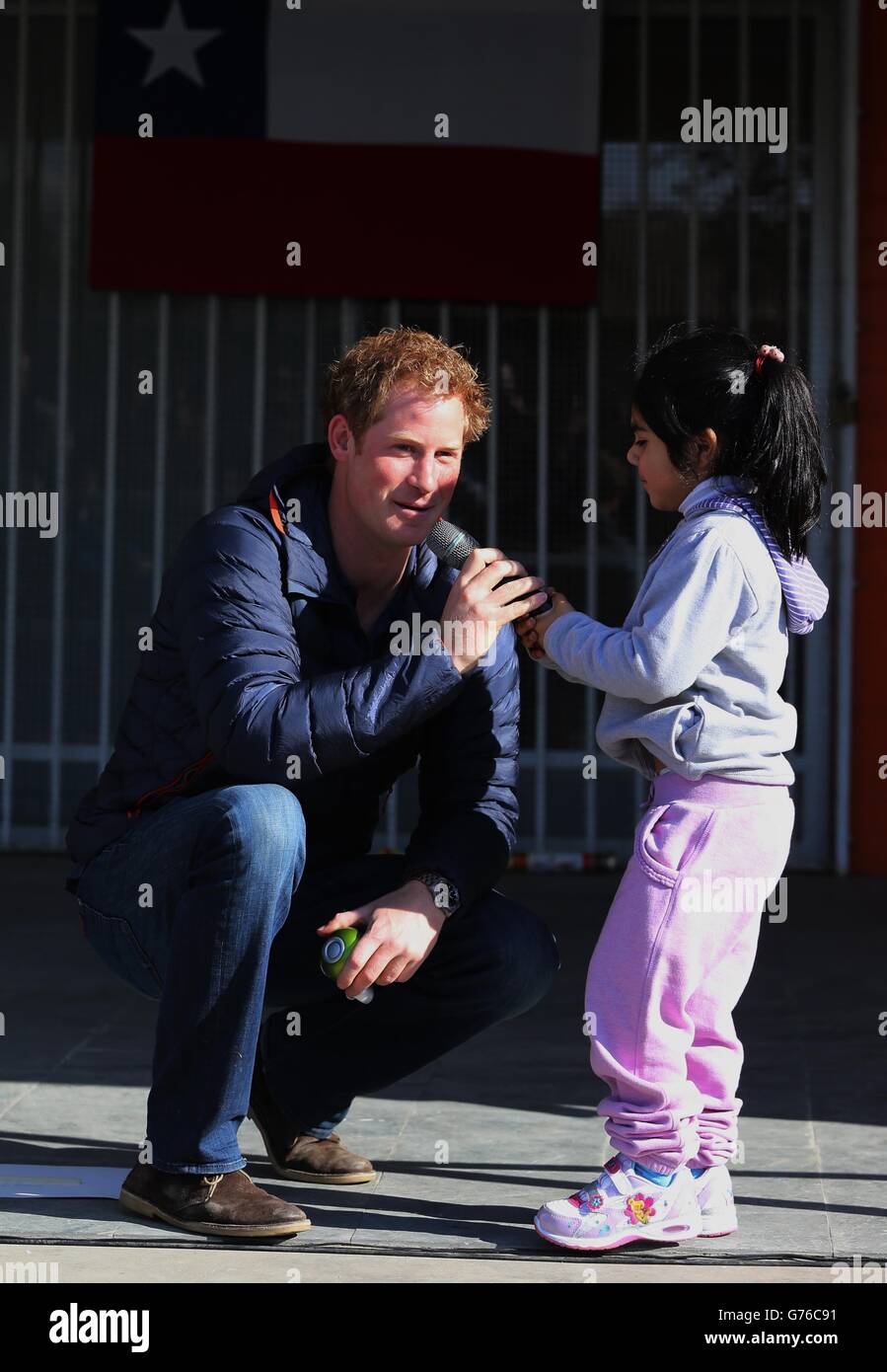 Pascal Vasquez 7 steals the microphone from Prince Harry as he meets children with mental and physical disabilities at the Fundacion Amigos de Jesus in Santiago Chile. Stock Photo