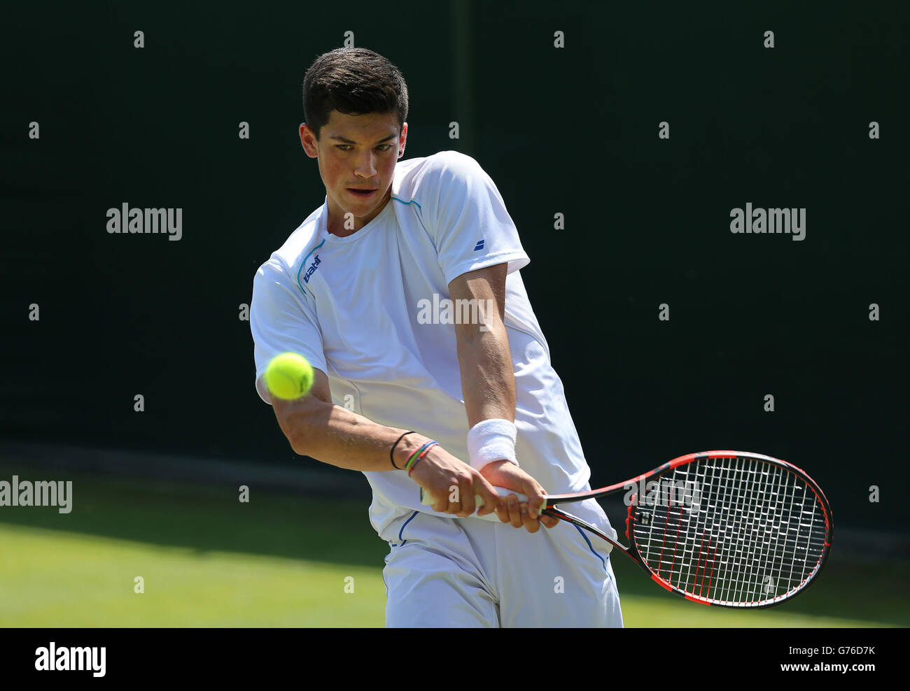 Great Britains Julian Cash in his Boys Singles match against USAs Taylor Harry Fitz during day nine of the Wimbledon Championships at the All England Lawn Tennis and Croquet Club, Wimbledon Stock