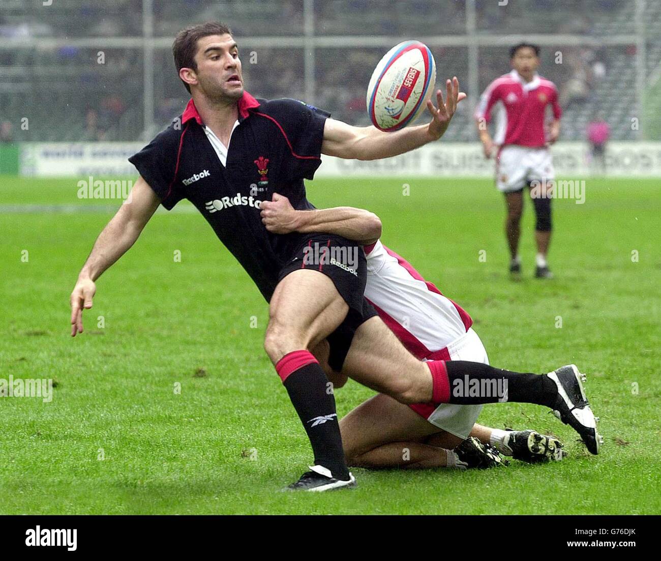 Wales v Singapore - Rugby Sevens. Wales' Gareth Baber is tackled by Singapore's Grant Rawlinson during Wales' 29-7 victory in the second round of the Hong Kong 'Sevens. Stock Photo