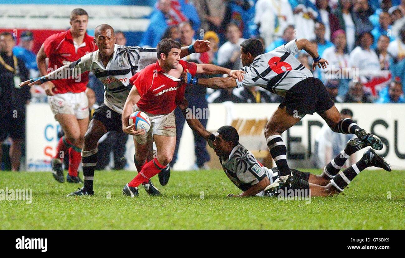 Wales' Gareth Baber is firmly held as Fiji win 17-0 in their 3rd round of the Hong Kong 'Sevens'. Stock Photo