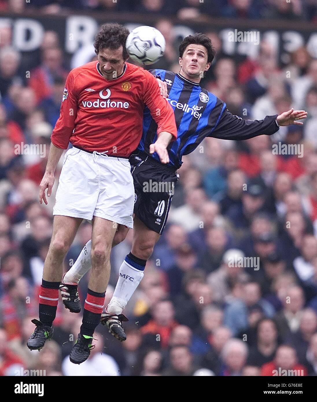 Manchester United's Laurent Blanc (left) and Benito Carbone of Middlesbrough (right) jump together during their FA Barclaycard Premiership match at Man Utd's Old Trafford stadium. Final Score: Man Utd 0 Middlebrough 1. Stock Photo