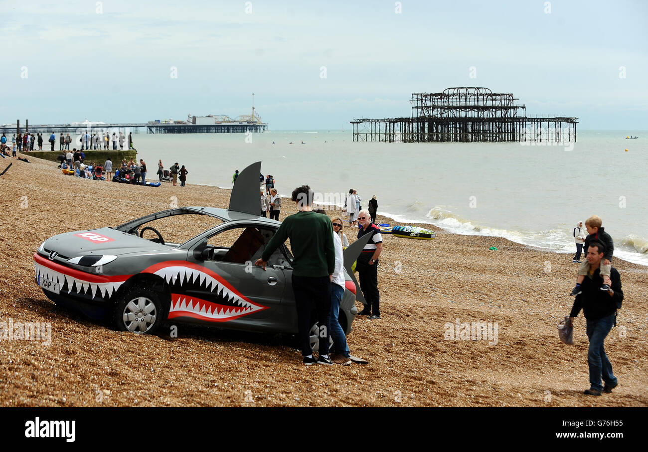 A raft made out of a car sits in the beach after taking part in the ...