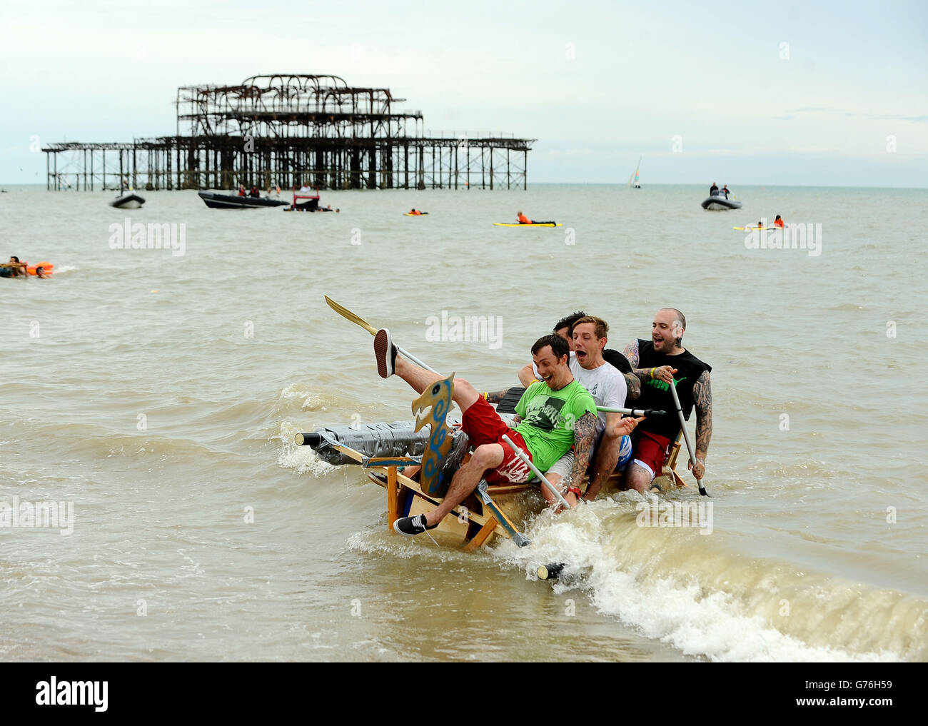 Competitors take part in the 'Paddle Something Unusual' event at the Paddle Round The Pier Beach Festival in Brighton. Stock Photo
