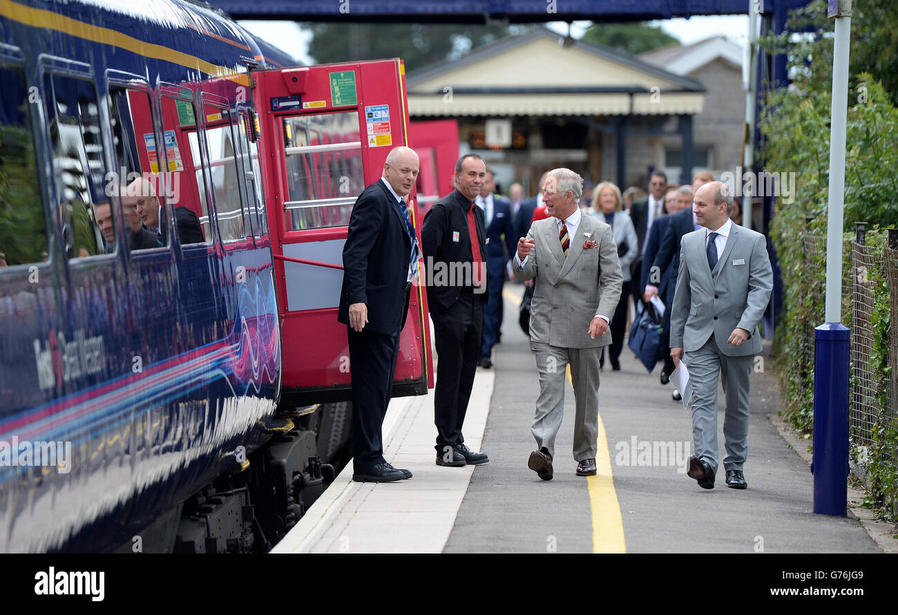 The Prince of Wales makes his way along the platform with Mark Hopwood (right), Managing Director of First Great Western Trains, before boarding a train to London Paddington after meeting staff during a visit to Castle Cary Railway Station. Stock Photo