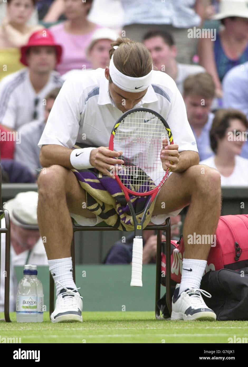 EDITORIAL USE ONLY, NO COMMERCIAL USE. Roger Federer of Switzerland is  disconsolate after losing to the 18 year old Mario Ancic, of Croatia at  Wimbledon. The 7th seed lost in straight sets