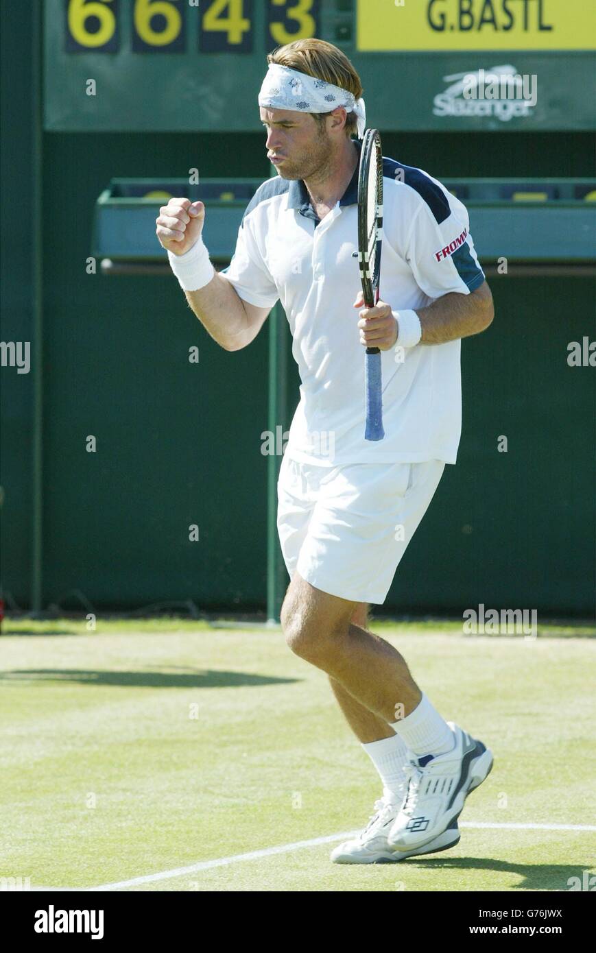 , NO COMMERCIAL USE. Un-seeded Swiss tennis player George Bastl celebrates break point against seven times Wimbledon Champion Pete Sampras in a five set epic at The All England Lawn Tennis Club. Bastl eventually triumphed 6:3/6:2/4:6/3:6/6:4. Stock Photo
