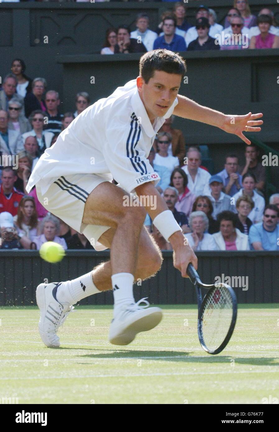 Britain's number one men's tennis star Tim Henman stoops to a back hand
