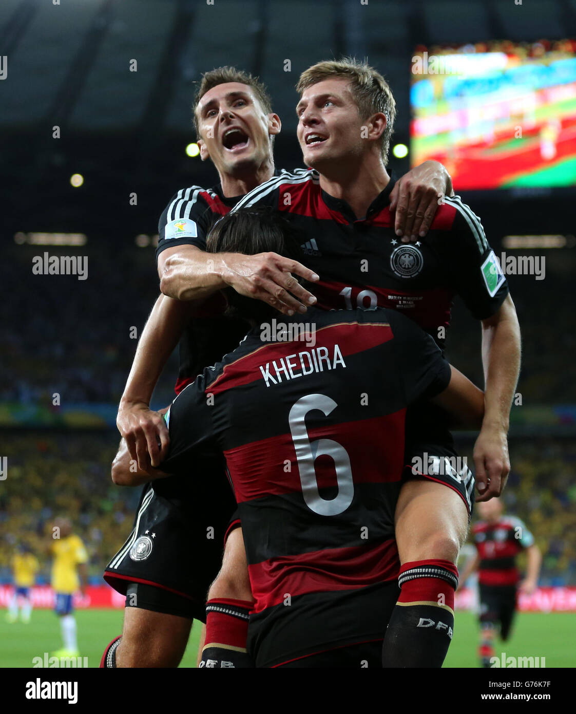 Germany's Toni Kroos celebrates scoring his side's fourth goal of the game with teammate Germany's Sami Khedira (6) and Miroslav Klose (left) during the FIFA World Cup Semi Final at Estadio Mineirao, Belo Horizonte, Brazil. Stock Photo