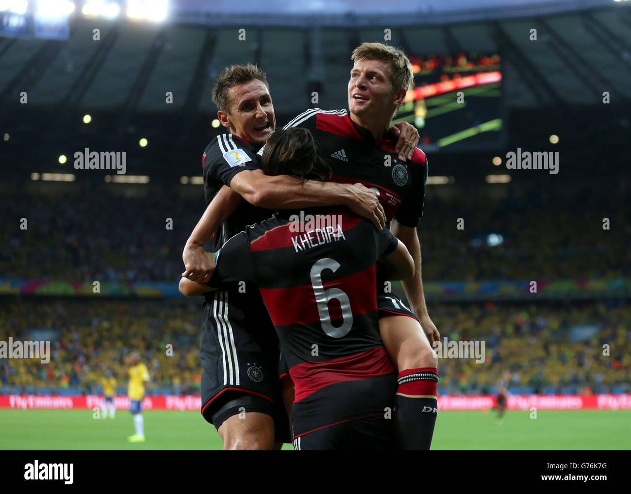 Germany's Toni Kroos celebrates scoring his side's fourth goal of the game with teammate Germany's Sami Khedira (6) and Miroslav Klose (left) during the FIFA World Cup Semi Final at Estadio Mineirao, Belo Horizonte, Brazil. Stock Photo