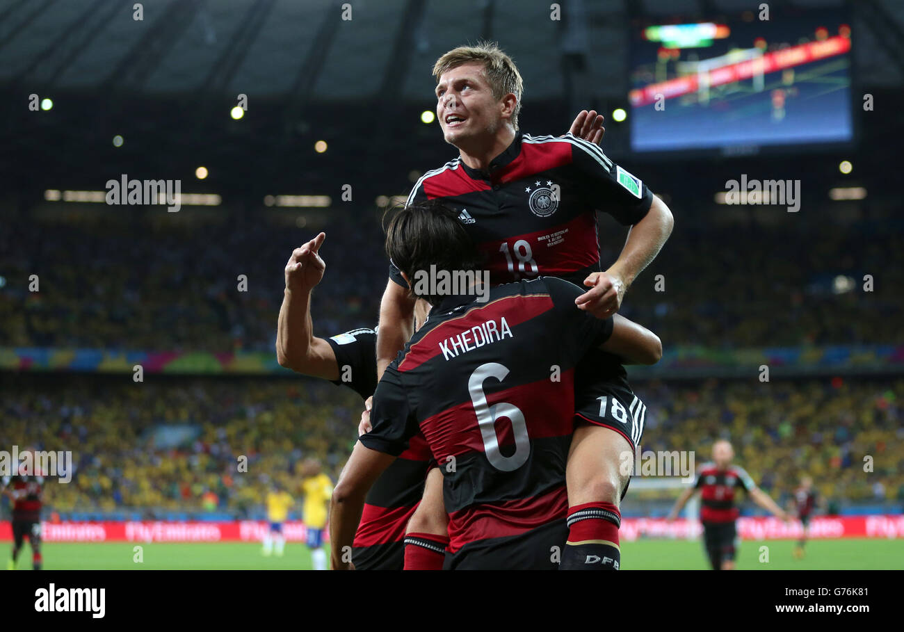 Germany's Toni Kroos celebrates scoring his side's fourth goal of the game with teammate Germany's Sami Khedira (6) during the FIFA World Cup Semi Final at Estadio Mineirao, Belo Horizonte, Brazil. Stock Photo