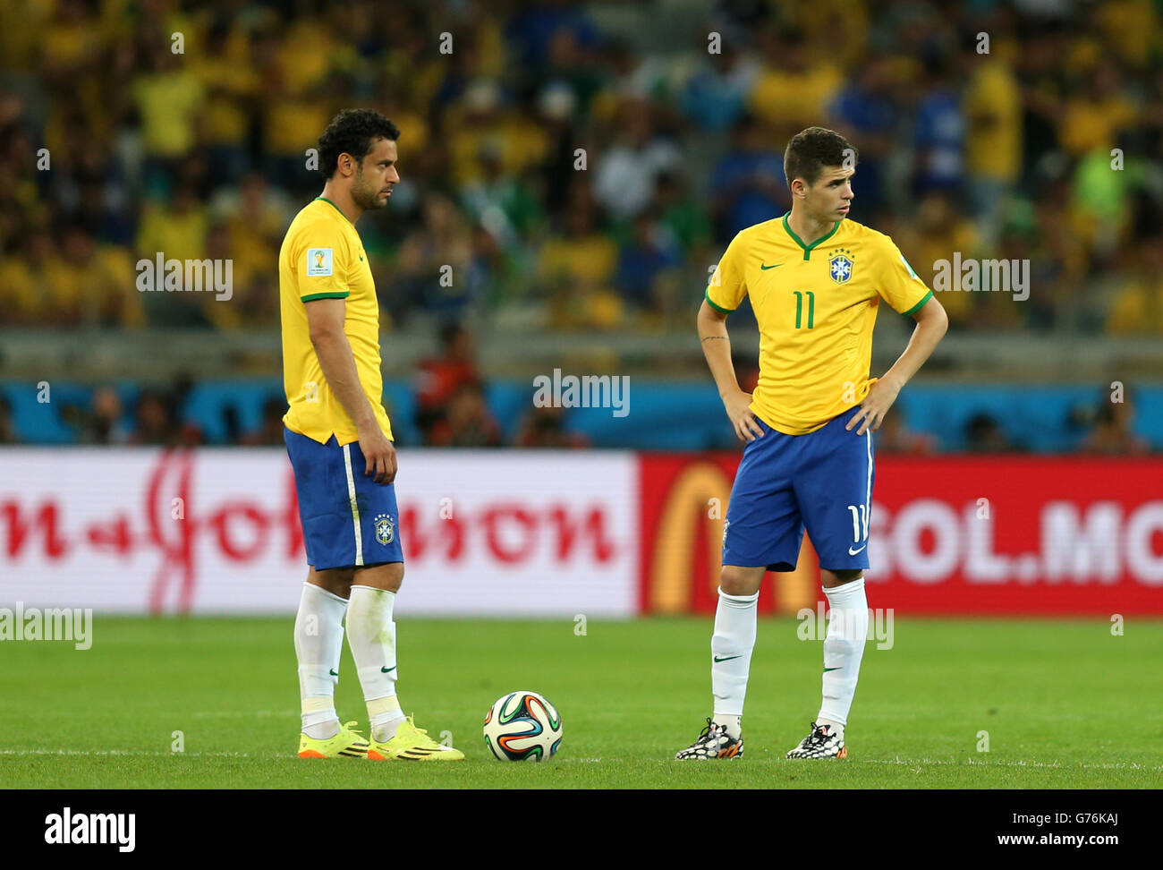 (left to right) Brazil's Fred and Oscar dejected at the kick off for the second half during the FIFA World Cup Semi Final at Estadio Mineirao, Belo Horizonte, Brazil. Stock Photo