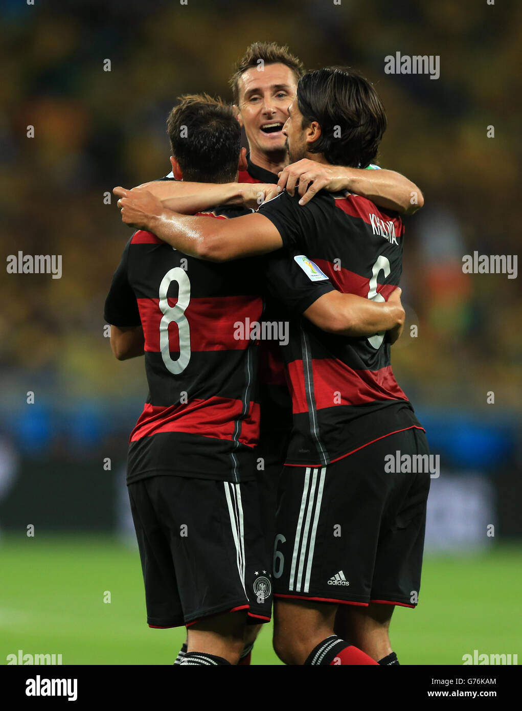 Germany's Sami Khedira (right) celebrates scoring his side's fifth goal of the game with teammates Mesut Ozil (left) and Miroslav Klose (centre) during the FIFA World Cup Semi Final at Estadio Mineirao, Belo Horizonte, Brazil. Stock Photo