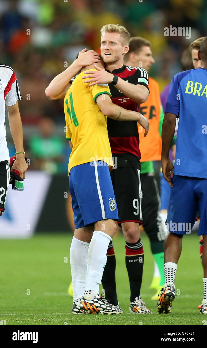 Germany's Andre Schurrle (right) consoles Brazil's Oscar (left) after the final whistle during the FIFA World Cup Semi Final at Estadio Mineirao, Belo Horizonte, Brazil. Stock Photo