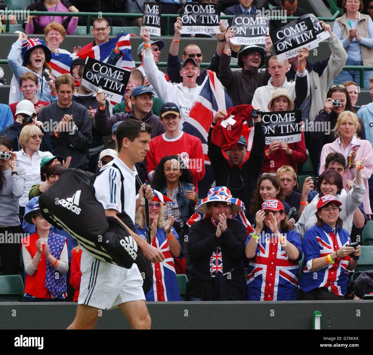 Britain's number one tennis star Tim Henman walks onto Court One cheered on by his loyal fans before playing against the Swiss Michel Kratochvil in the fourth round. Stock Photo