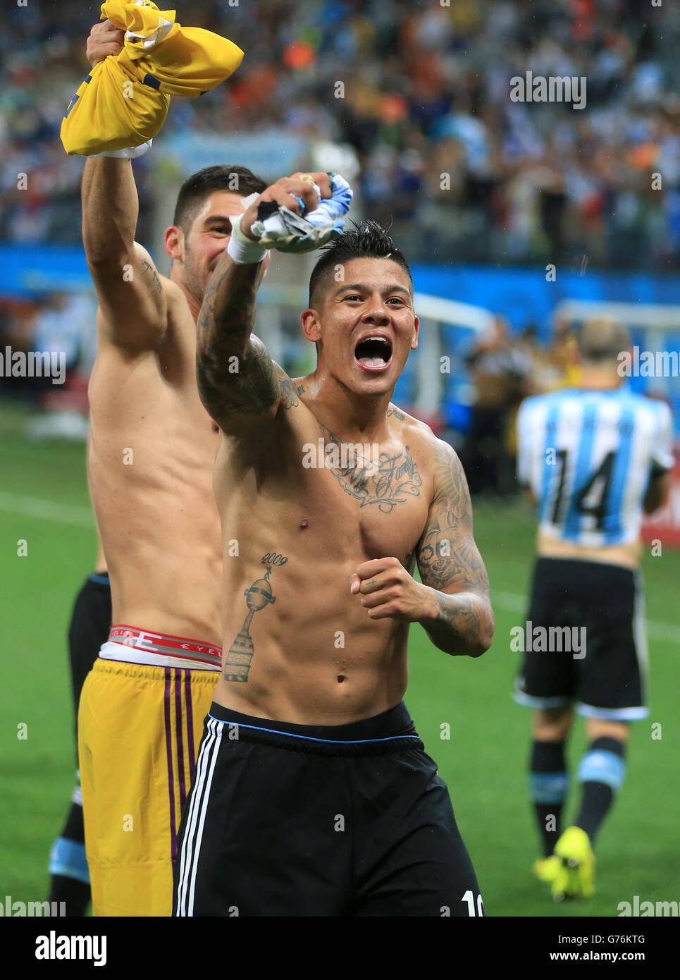 Argentina's Marcos Rojo (centre) celebrates victory in the penalty shoot-out with team-mates following the FIFA World Cup Semi Final at the Arena de Sao Paulo, Sao Paulo, Brazil. Stock Photo
