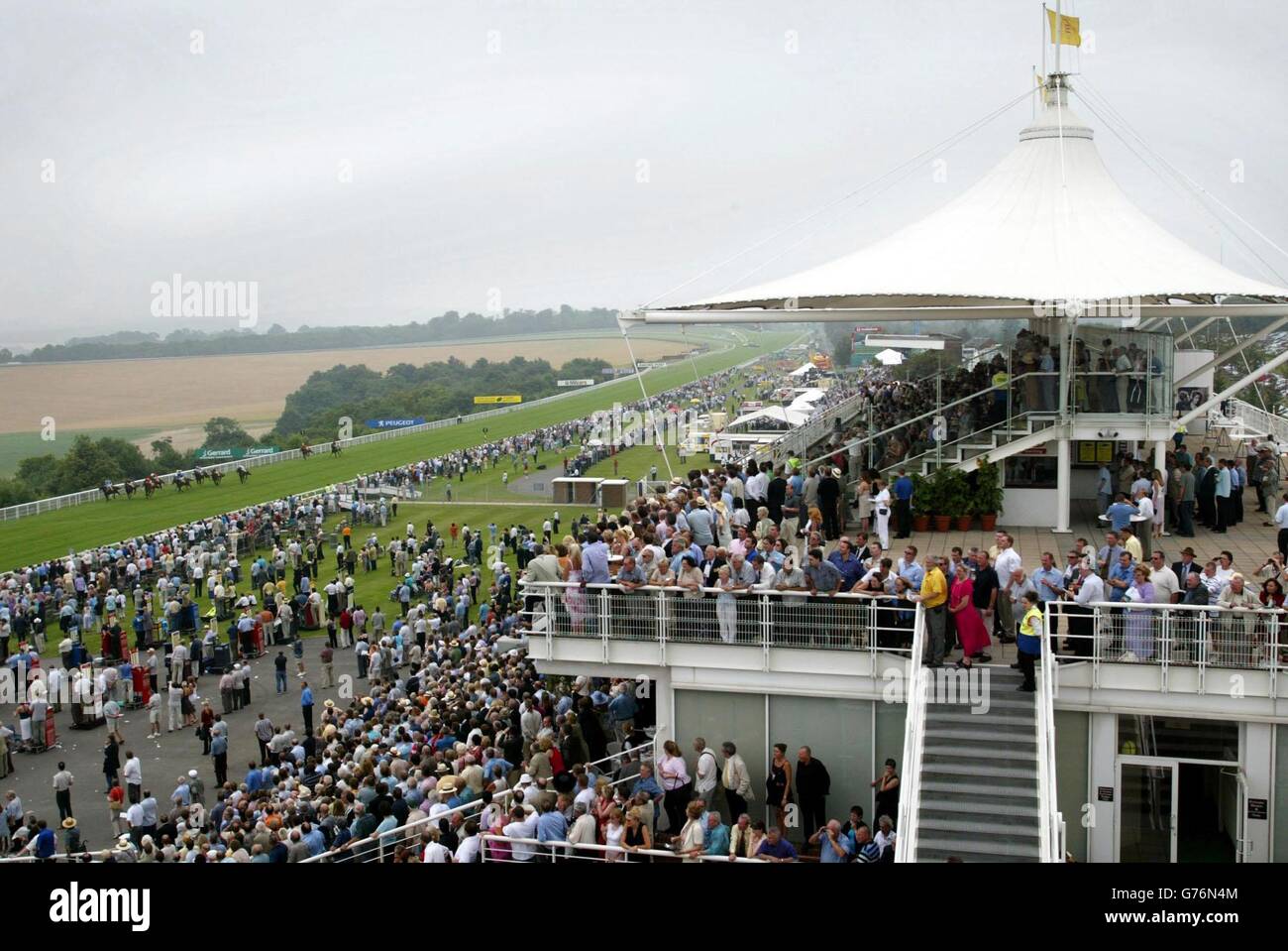 Race goers flock to the Goodwood Festival in West Sussex. Officials at Goodwood reported the track in wonderful condition ahead of the five-day Glorious meeting which gets under way on today. Stock Photo