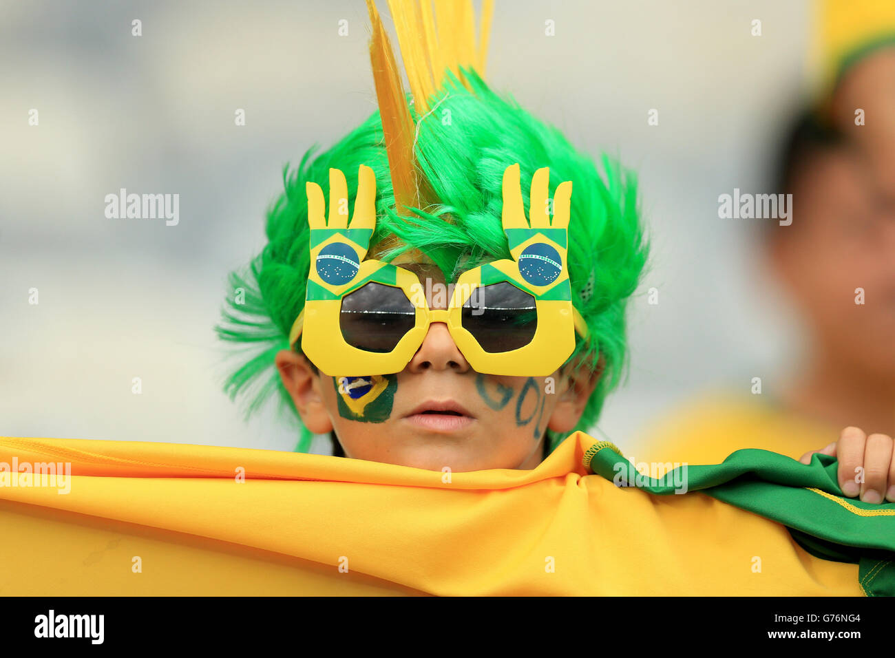 A Brazil fan wearing bright glasses and a green and yellow wig inside the Estadio Mineirao before the FIFA World Cup Semi Final at Estadio Mineirao, Belo Horizonte, Brazil. Stock Photo