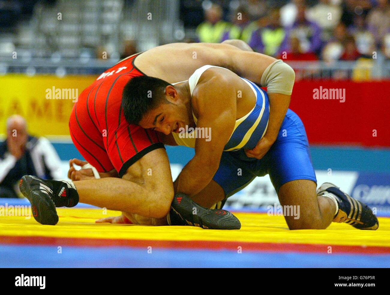 England's Jatinder Singh (Blue) in action against Malta's Abraham Vassallo during the pool section of the mens 84kg wrestling at the Commonwealth Games, G MEX, Manchester. Stock Photo