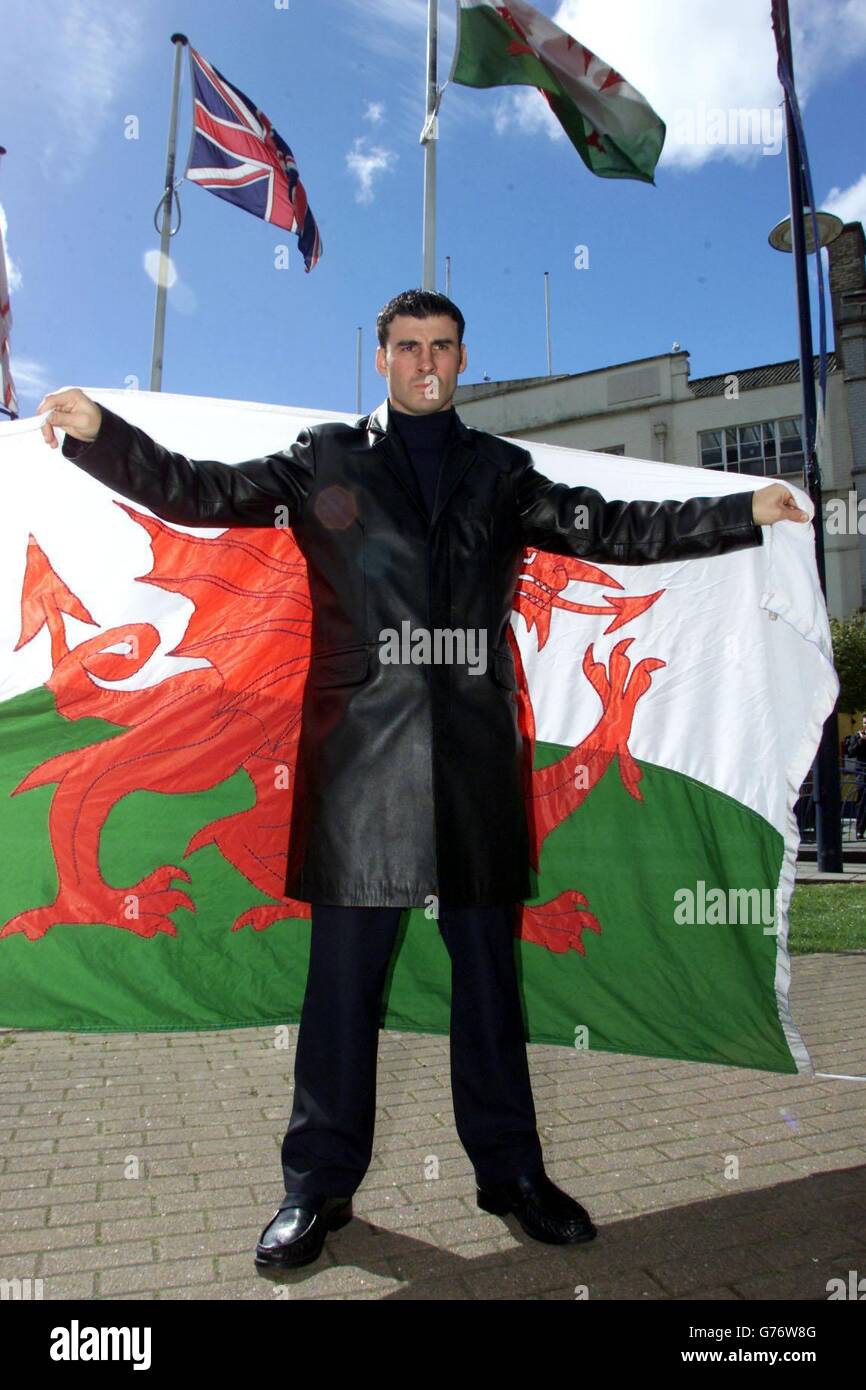 WBO Super-Middleweight Champion Joe Calzaghe, stands with the Welsh flag at the Marriott Hotel, Cardiff, Wales. Wales'Joe Calzaghe takes on Philadelphia's Charles Brewer in a WBO World super-middleweight title fight at Cardiff International Arena on Saturday. Stock Photo