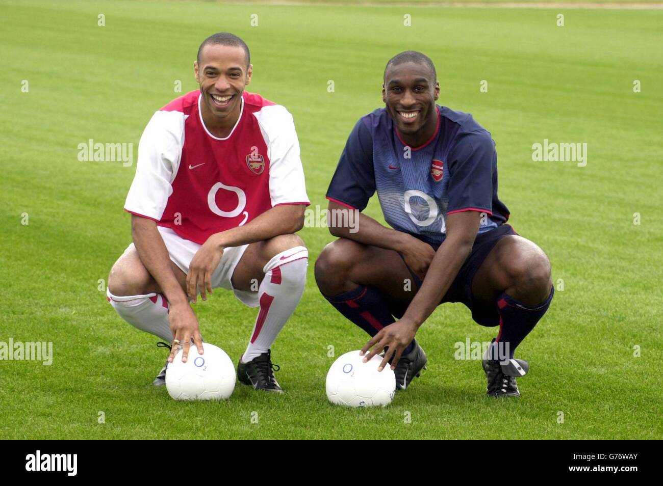 Arsenal players Thierry Henry (left) and Sol Campbell, model the club's new football strip, promoting their new sponsor's logo at London Colney. Arsenal have signed a sponsorship deal with O2, a leading provider of mobile communications services in Europe. * From August this year, O2 will become the official club sponsor and exclusive mobile communications partner to Arsenal, in the biggest club sponsorship deal the Gunners have ever signed. . Stock Photo