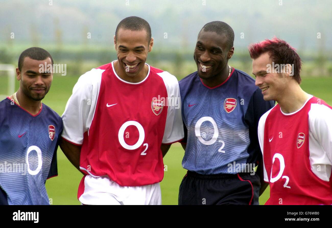 Arsenal players (from left to right) Ashley Cole, Thierry Henry, Sol Campbell, and Freddie Ljungberg model the club's new football strip, promoting their new sponsor's logo at London Colney. Arsenal have signed a sponsorship deal with O2, a leading provider of mobile communications services in Europe. From August this year, O2 will become the official club sponsor and exclusive mobile communications partner to Arsenal, in the biggest club sponsorship deal the Gunners have ever signed. . Stock Photo