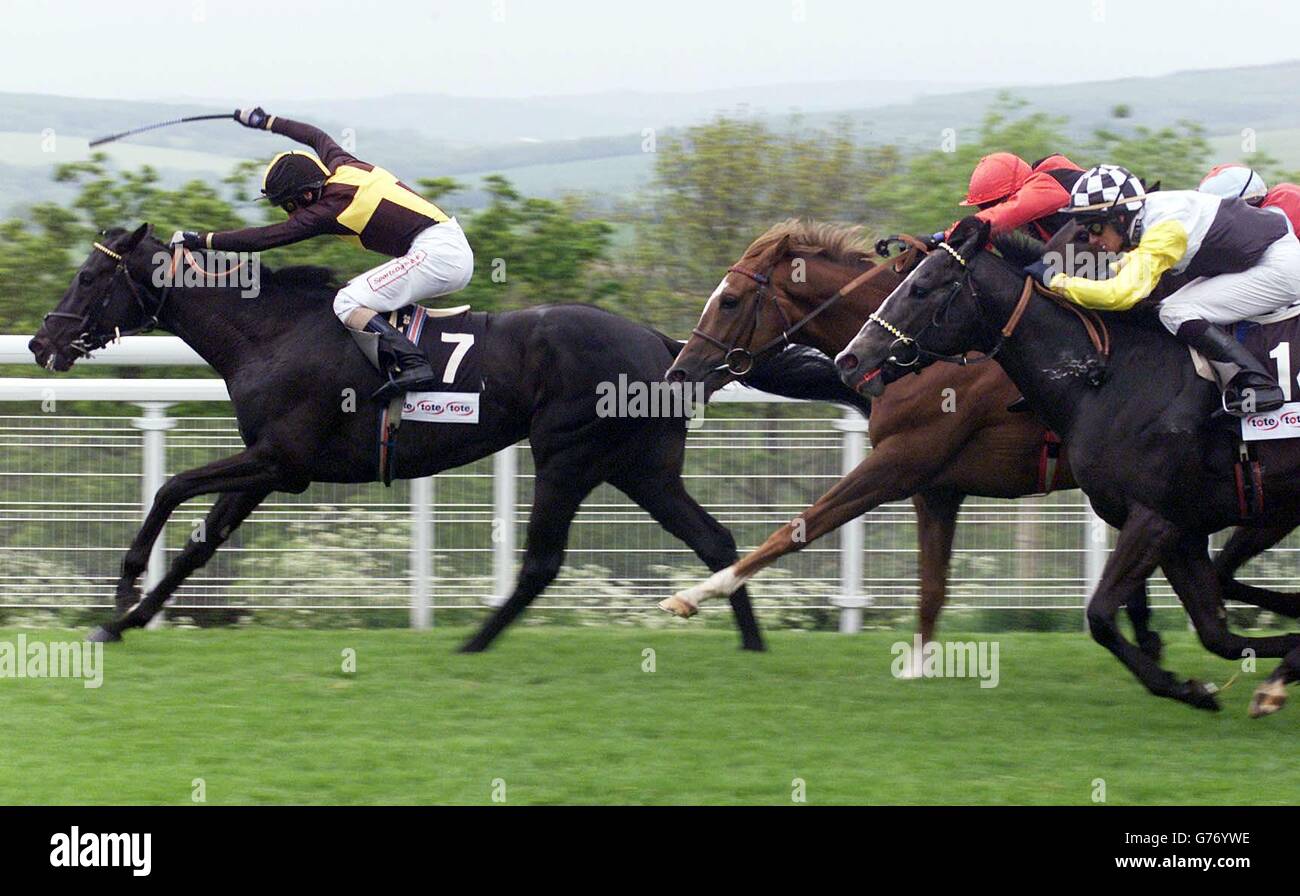 Passing Glance with jockey Martin Dwyer (left) wins ahead of Imbibing with jockey Gary Bardwell (red cap) in the Tote Trifecta Stakes at Goodwood. Stock Photo