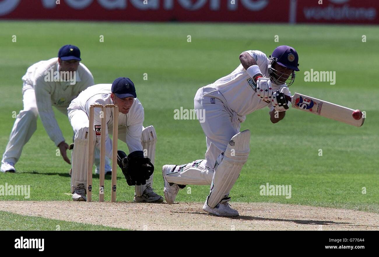Sri Lanka batsman Hashan Tillakaratne drives a delivery from Glamorgan's Robert Croft as wicketkeeper Mark Wallace looks on, during the first days play of the tourist match at Sophia Gardens, Cardiff. Stock Photo