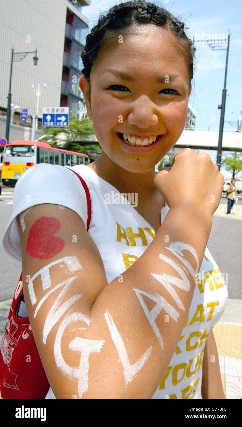 A Japanese supporter proudly shows her feelings for the England national team on the streets of Niigata, Japan, on the morning after they secured their place in the World Cup quarter finals by beating Denmark 3-0. Stock Photo